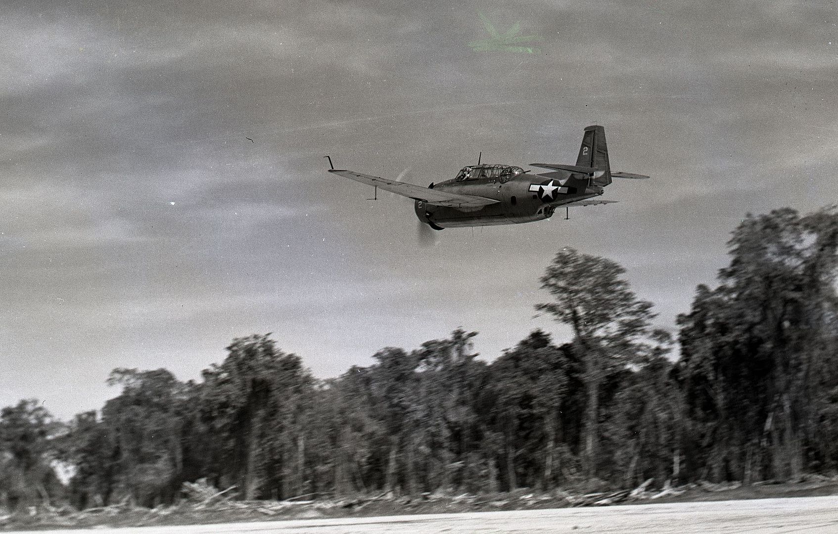 TBF Or Marine Torpedo Bomber Shown Here As It Takes Off Against The Jungle Background Of A Bougainville Airfield