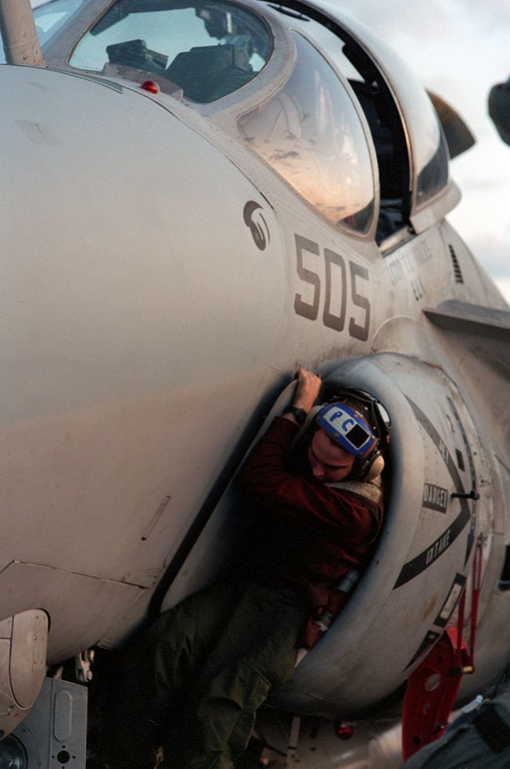 The Plane Captain Of An A 6E Intruder Aircraft Crawls Out Of An Intake Manifold During A Preflight Inspection On Board The Nuclear Powered Aircraft Carrier USS GEORGE WASHINGTON