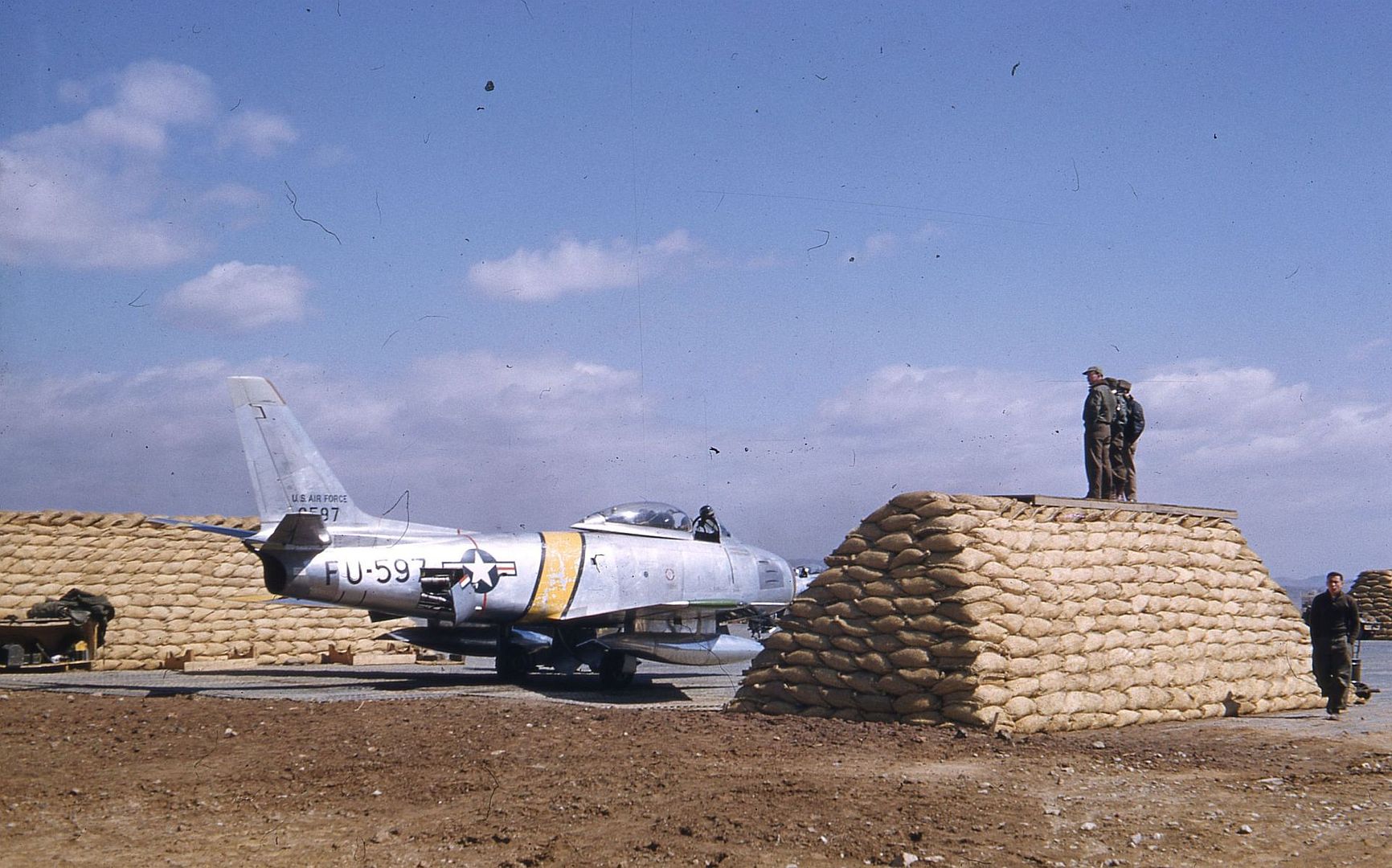 Three Quarter Right Rear View Of A North American F 86E Sabre Sn 50 597 Cn 170 19 Jet Parked Among Piles Of Sandbags